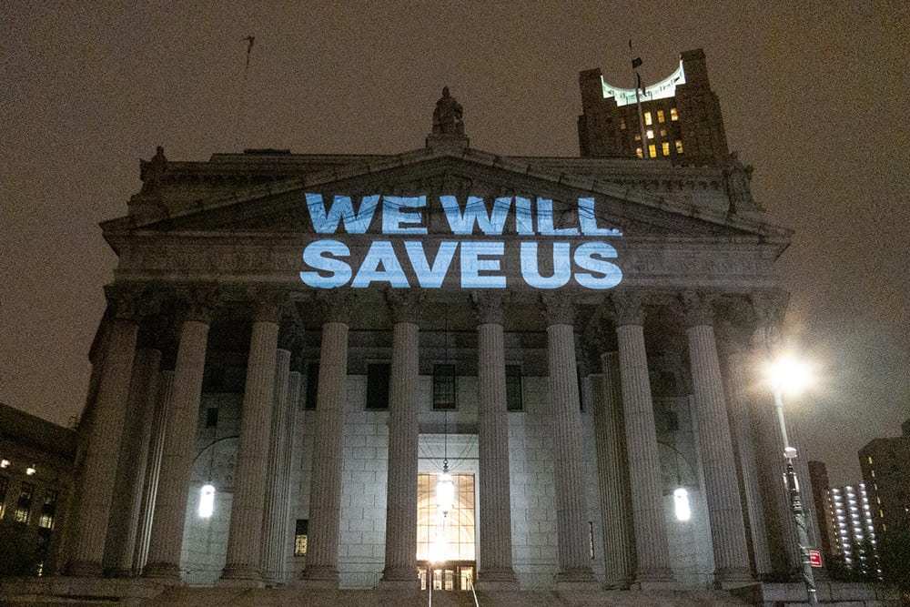Supreme Court building with we will save us written and projected onto it in protest of the roe vs wade decision