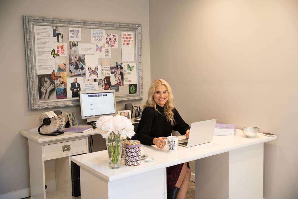 Supercharge Your Brand by Crafting a Clear and Compelling Offer - branding advisor Liz Dennery Sanders sitting at her office desk near a mug that reads nasty women get shit done